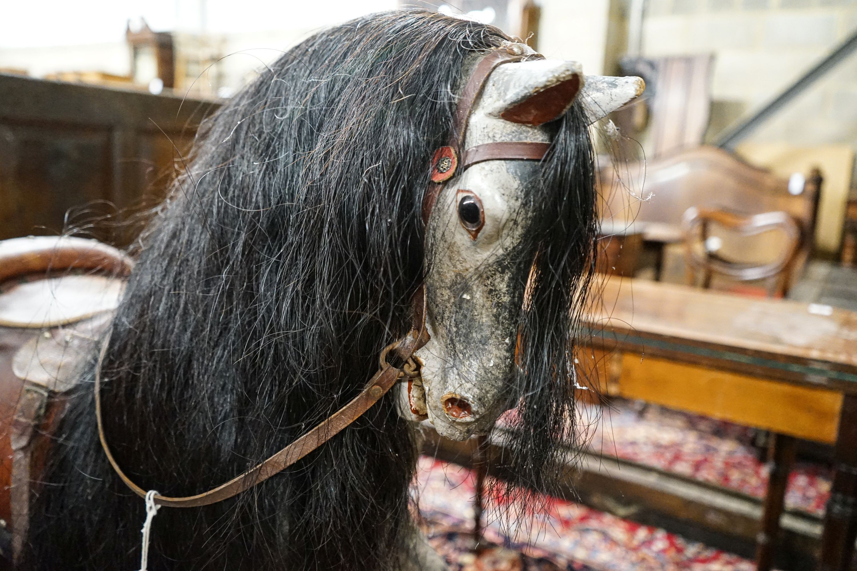 A large Edwardian Ayres type rocking horse on a turned safety frame, length 160cm, height 110cm